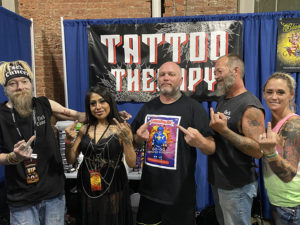 Group picture of the tattoo artist and Mathew.